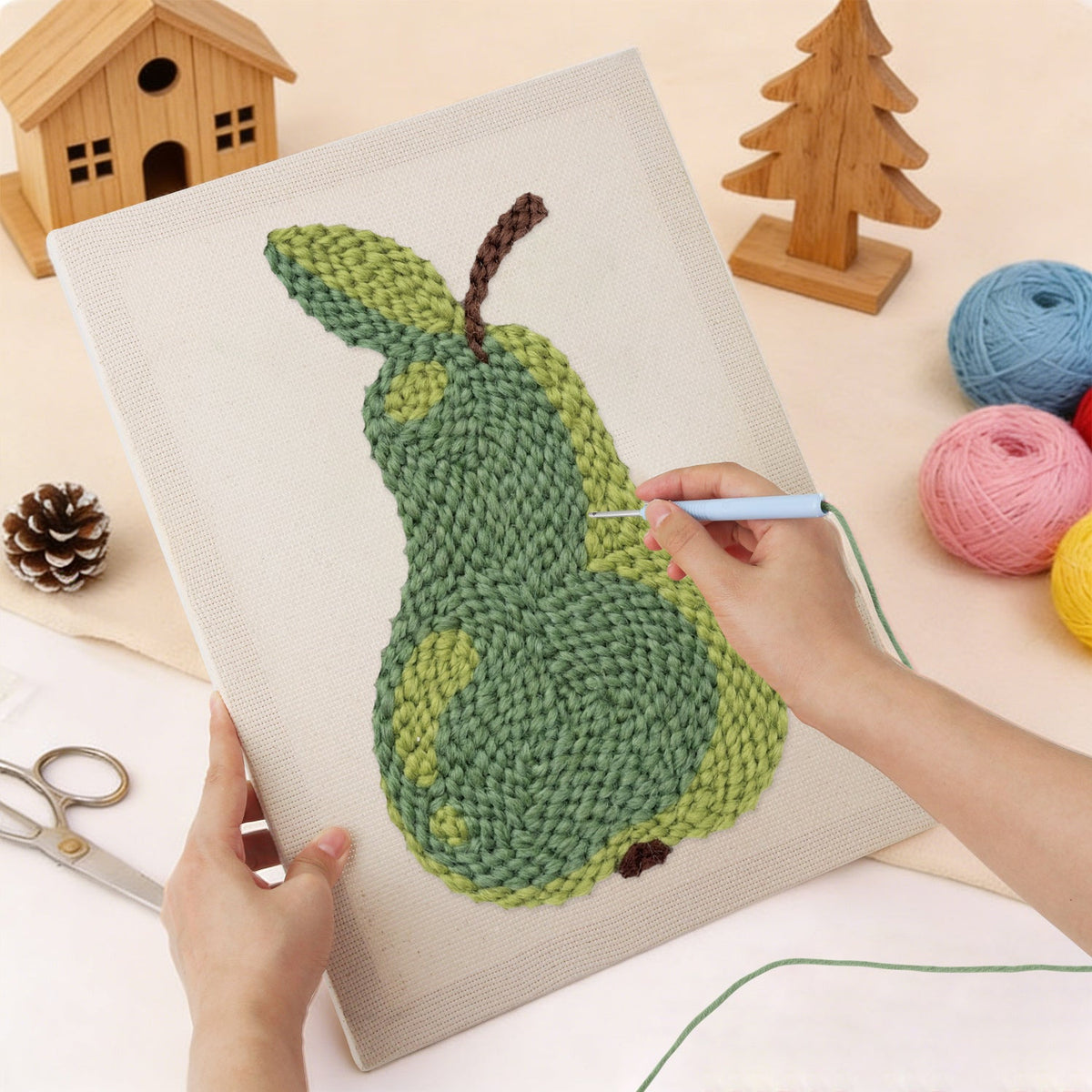 Punching the Green Pear design with the punch needle