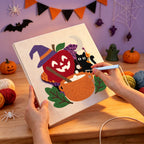 Punching the Apple Cauldron Cat design with the punch needle