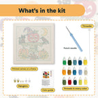 What is in the Apple Head Scarecrow kit: printed canvas, punch needle, threader, threads, color guide and hangers