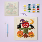 Apple Head Scarecrow canvas before and after punching, with the threads and tools