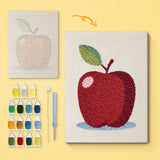 Apple on Blue canvas before and after punching, with the threads and tools