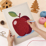 Punching the Apple on Blue design with the punch needle