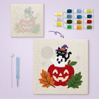 Apple Stack Friends canvas before and after punching, with the threads and tools