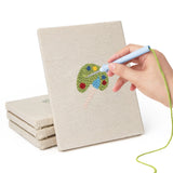 Hand punching one of the Art Class Palette mini canvases