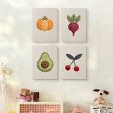 The four Avocado and Cherries mini canvases on a wall above a shelf