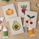 The four finished Avocado and Cherries mini canvases laid out on a table