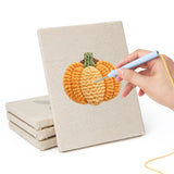 Hand punching one of the Avocado and Cherries mini canvases