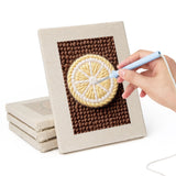 Hand punching one of the Avocado Watermelon mini canvases