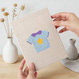 Hand holding a finished Baby Blue Outfits mini canvas