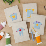 The four finished Baby Blue Outfits mini canvases laid out on a table