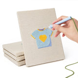 Hand punching one of the Baby Blue Outfits mini canvases