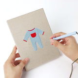 Punching a Baby Blue Outfits mini canvas with the punch needle