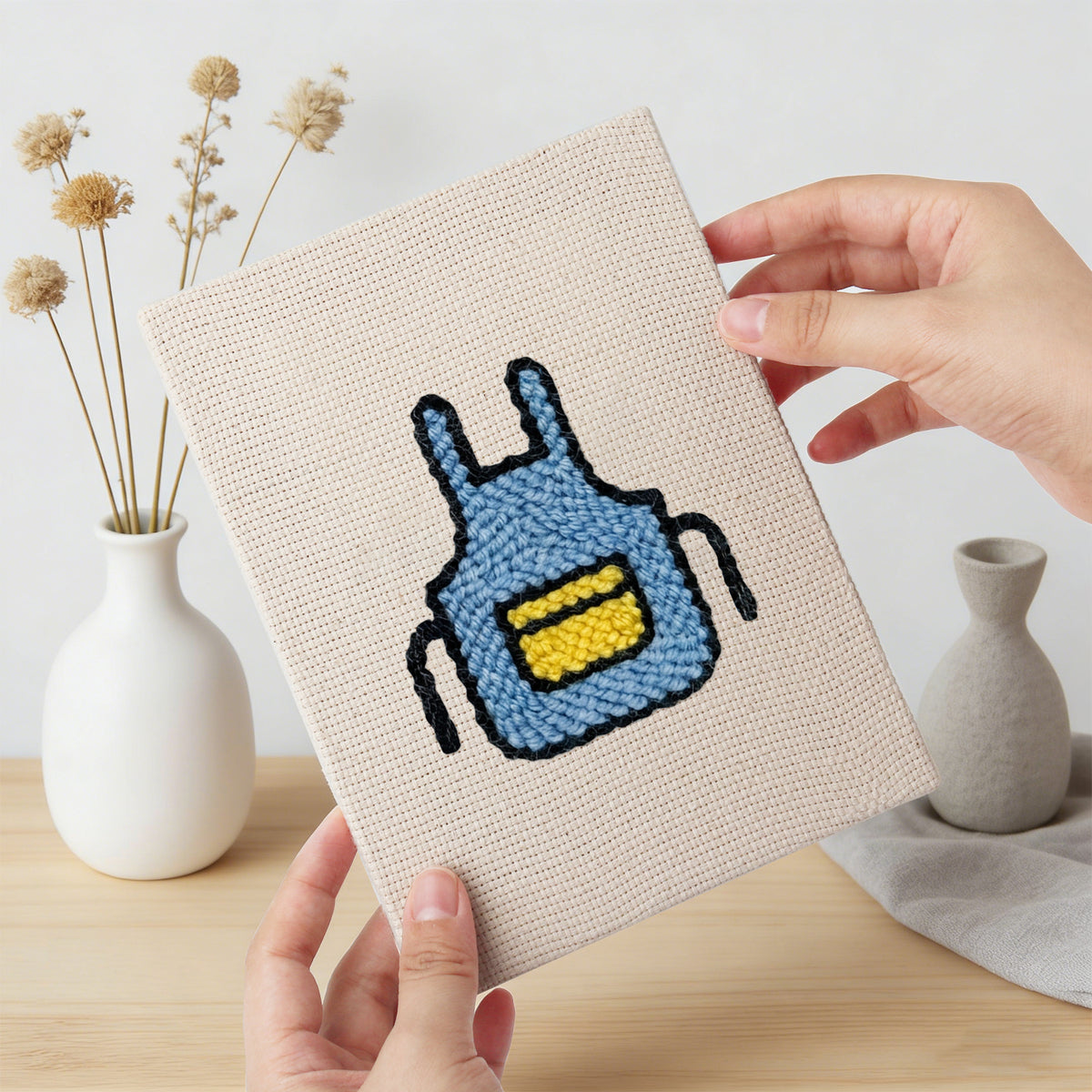 Hand holding a finished Backyard Burger Cook mini canvas