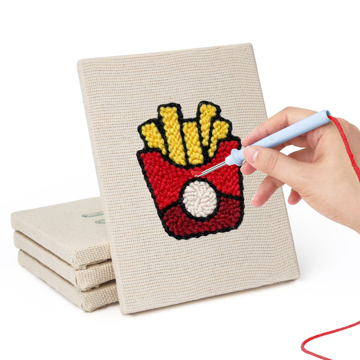 Hand punching one of the Backyard Burger Cook mini canvases