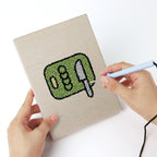 Punching a Backyard Burger Cook mini canvas with the punch needle