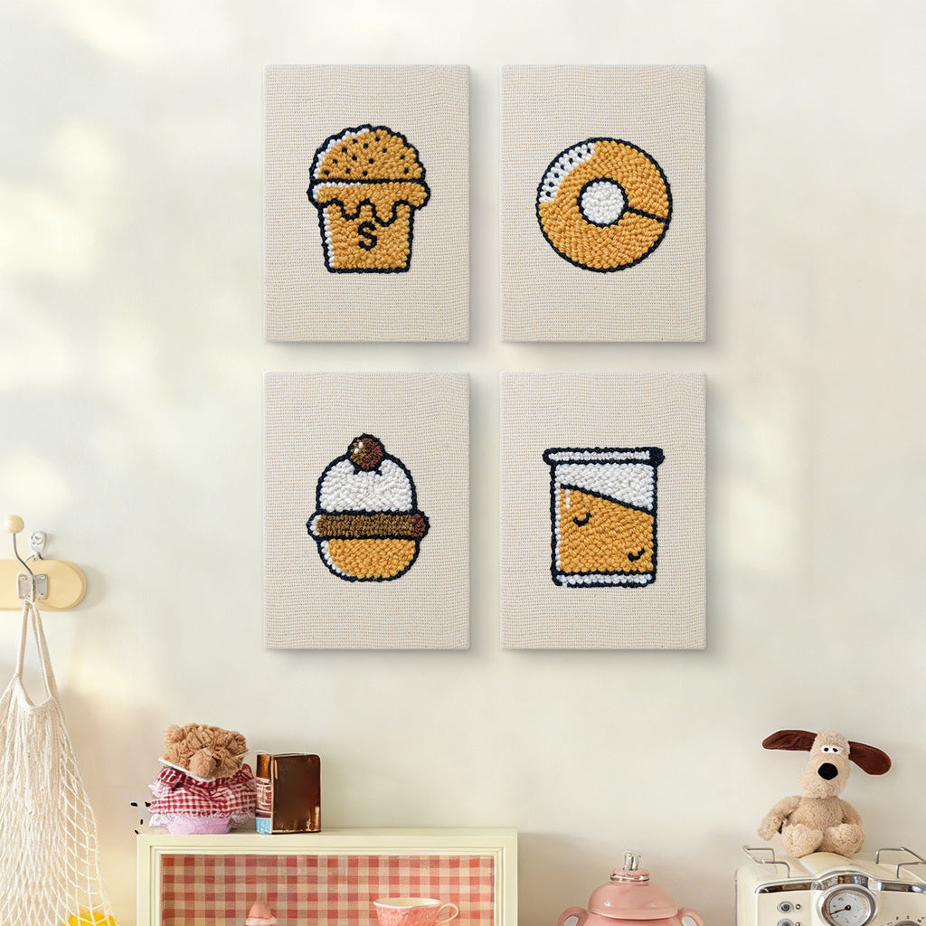 The four Bakery Treats mini canvases on a wall above a shelf