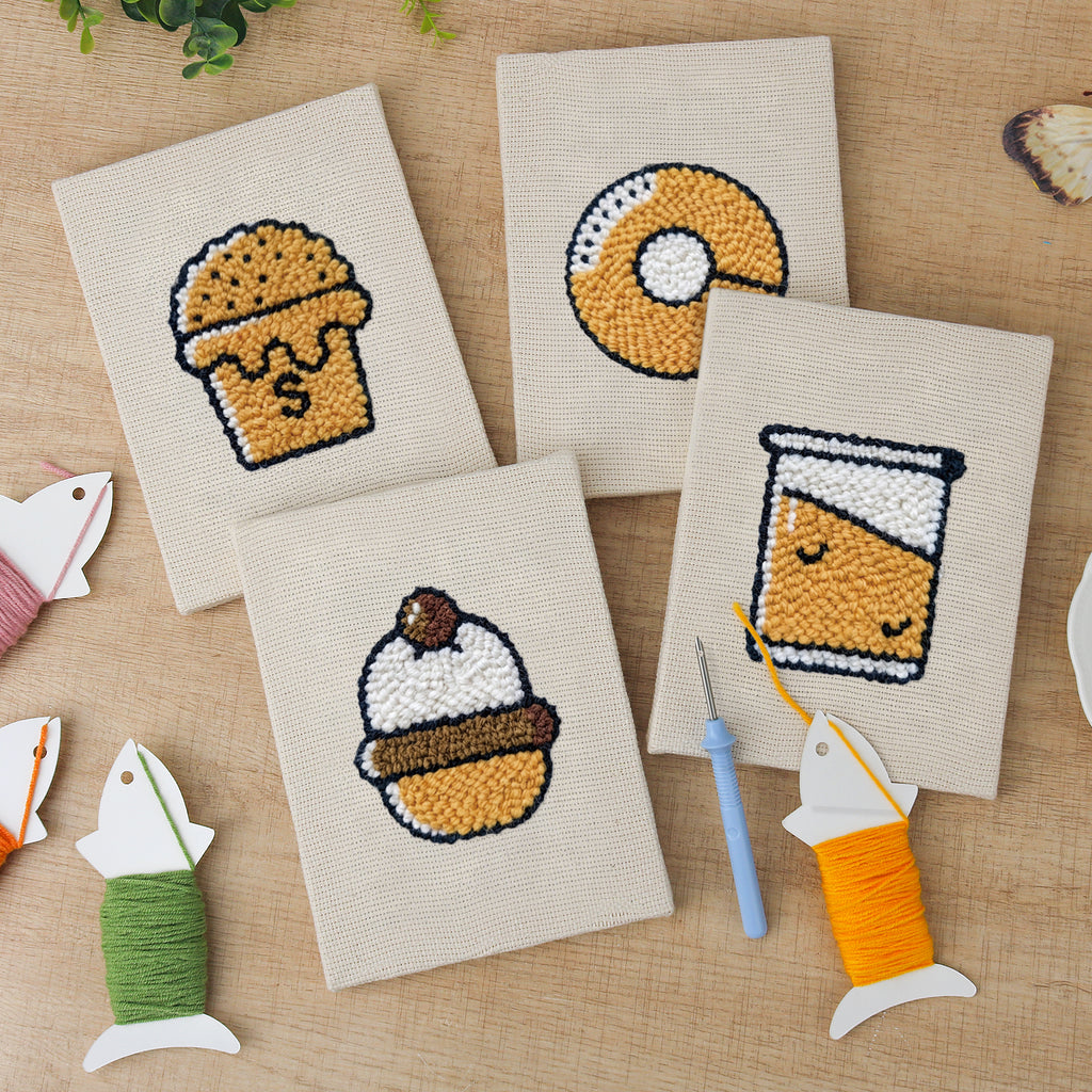 The four finished Bakery Treats mini canvases laid out on a table