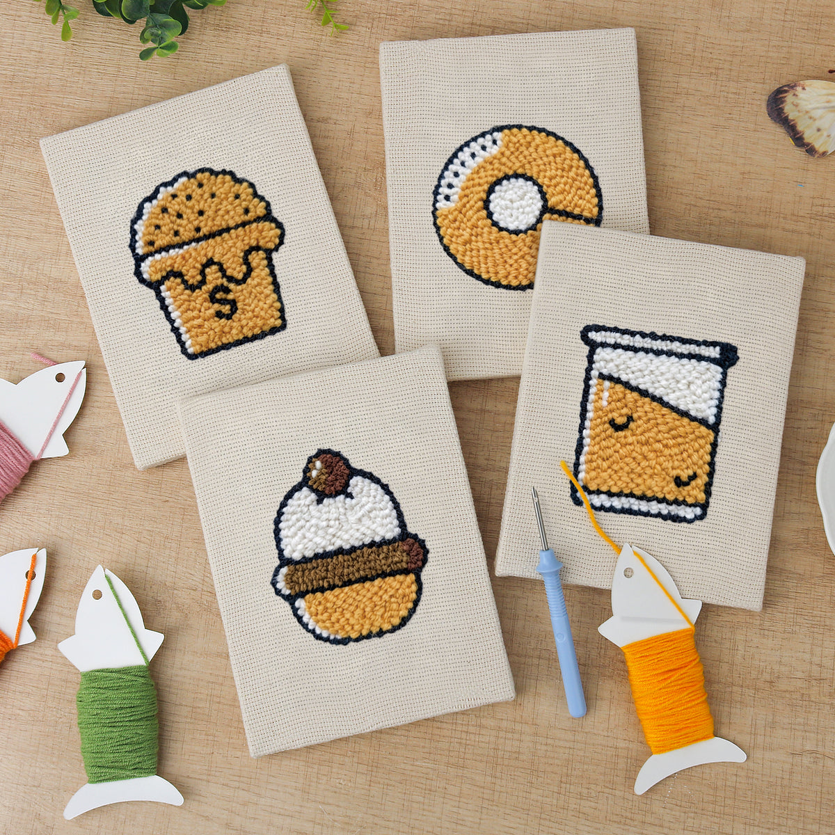 The four finished Bakery Treats mini canvases laid out on a table