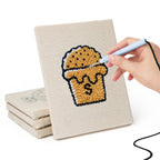 Hand punching one of the Bakery Treats mini canvases