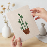 Hand holding a finished Bamboo Palm Pots mini canvas