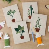 The four finished Bamboo Palm Pots mini canvases laid out on a table