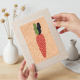 Hand holding a finished Banana and Radish mini canvas