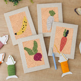 The four finished Banana and Radish mini canvases laid out on a table