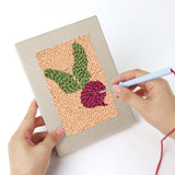 Punching a Banana and Radish mini canvas with the punch needle