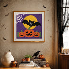 Finished Bat and Three Pumpkins punch needle canvas on a wall