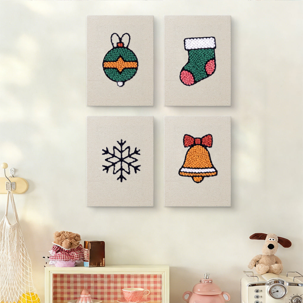 The four Bauble and Snowflake mini canvases on a wall above a shelf