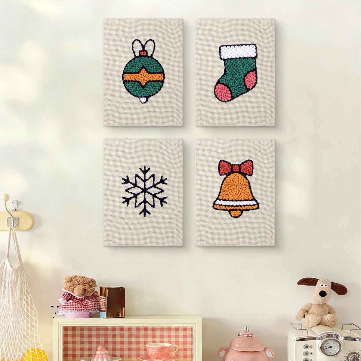 The four Bauble and Snowflake mini canvases on a wall above a shelf
