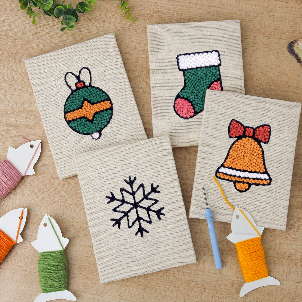 The four finished Bauble and Snowflake mini canvases laid out on a table