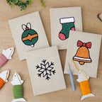 The four finished Bauble and Snowflake mini canvases laid out on a table