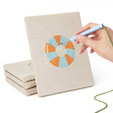 Hand punching one of the Beach Day Essentials mini canvases