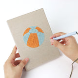 Punching a Beach Day Essentials mini canvas with the punch needle