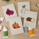 The four finished Beet and Garlic mini canvases laid out on a table