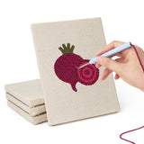 Hand punching one of the Beet and Garlic mini canvases