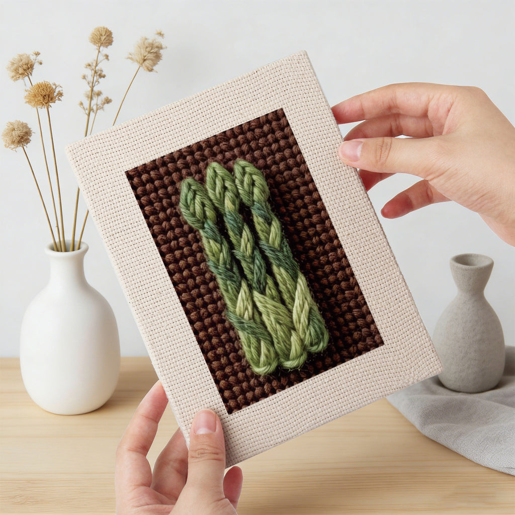 Hand holding a finished Beet Carrot Eggplant mini canvas