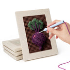 Hand punching one of the Beet Carrot Eggplant mini canvases