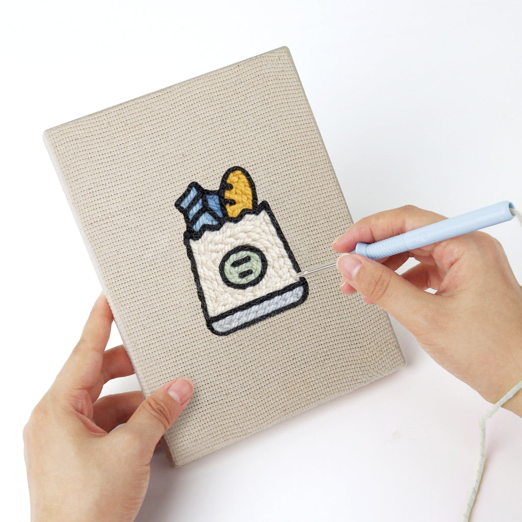 Punching a Berry Roll Cake mini canvas with the punch needle