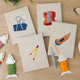 The four finished Binder Clip Tools mini canvases laid out on a table