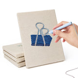 Hand punching one of the Binder Clip Tools mini canvases