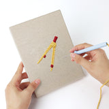 Punching a Binder Clip Tools mini canvas with the punch needle