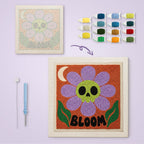 Bloom Skull Flower canvas before and after punching, with the threads and tools