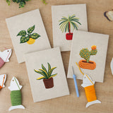 The four finished Blooming Cactus Shelf mini canvases laid out on a table