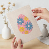 Hand holding a finished Blue Bloom Eggs mini canvas