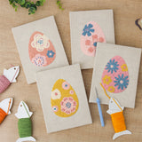 The four finished Blue Bloom Eggs mini canvases laid out on a table