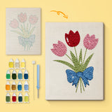 Blue Bow Tulips canvas before and after punching, with the threads and tools