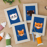 The four finished Blue Cat Portraits mini canvases laid out on a table