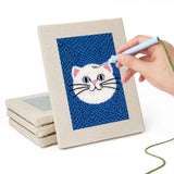 Hand punching one of the Blue Cat Portraits mini canvases
